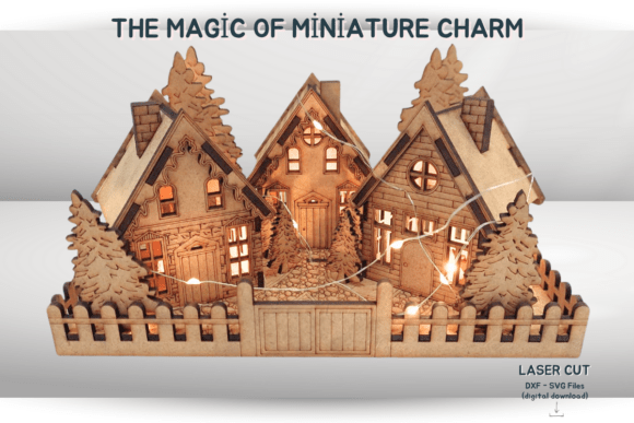 Miniature laser cut Christmas village with wooden houses and evergreen trees